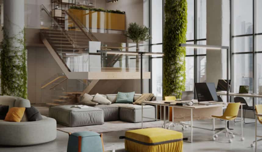 Modern office space with vertical gardens, cozy seating, desks, computers, and a staircase.